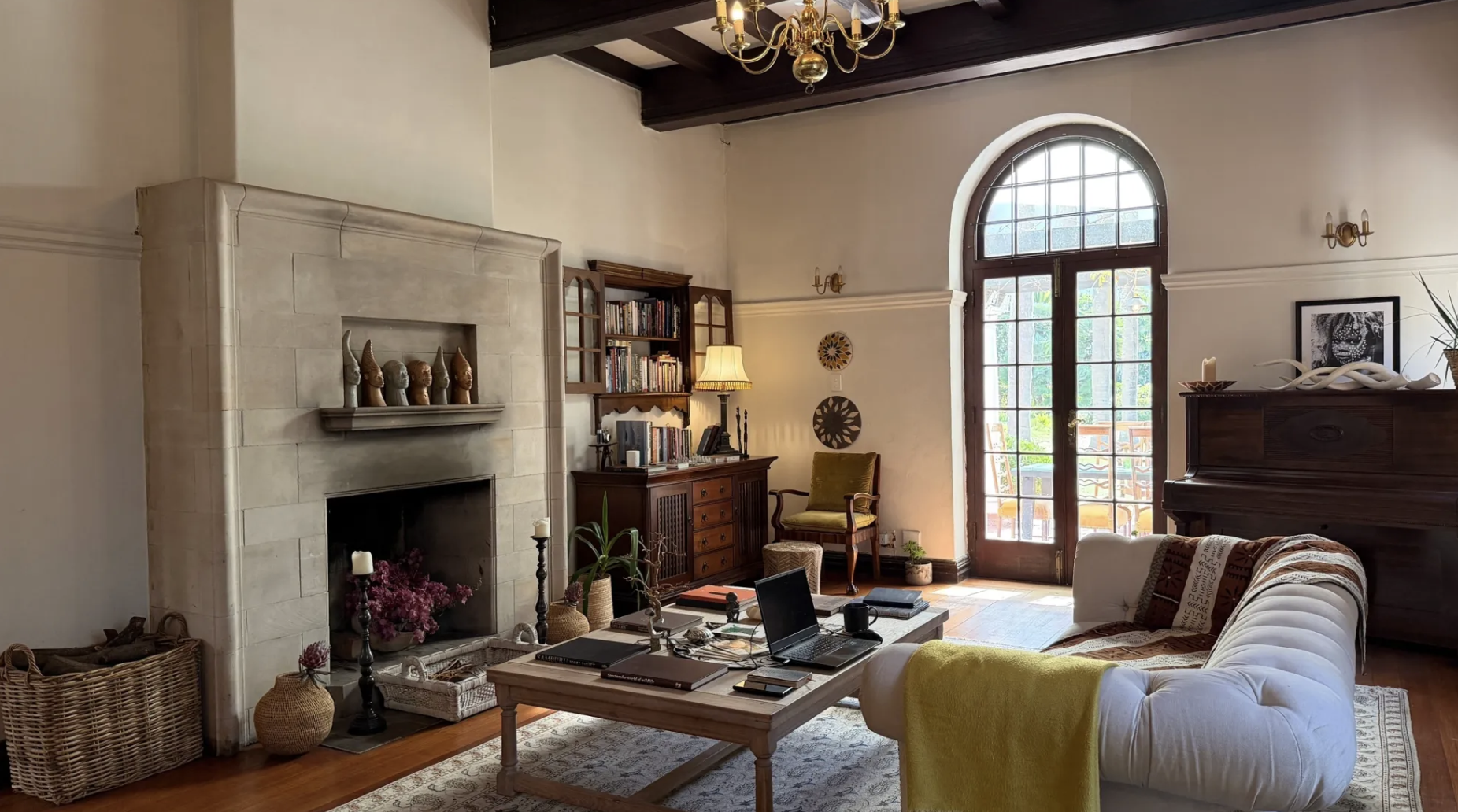 The living room at MANTI — fireplace, chandelier and arched window