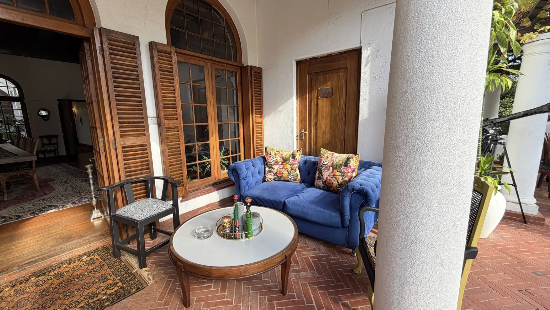 Blue velvet sofa on the brick terrace — relaxed seating at MANTI